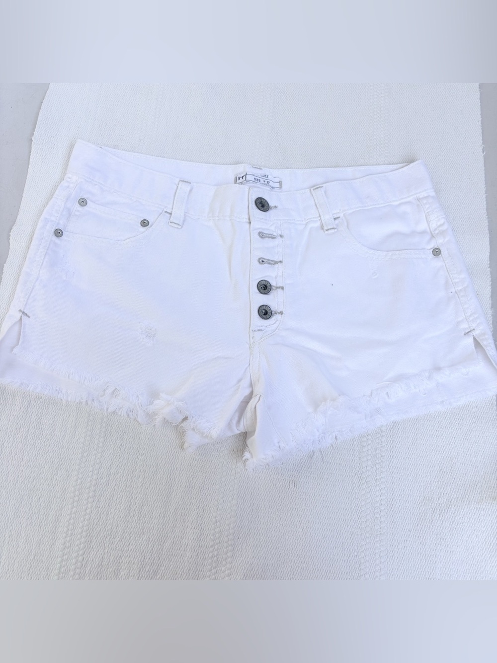 Free People "Loving Good Vibrations" white denim shorts size 27